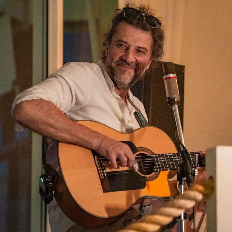 Guitarist smiling and playing guitar